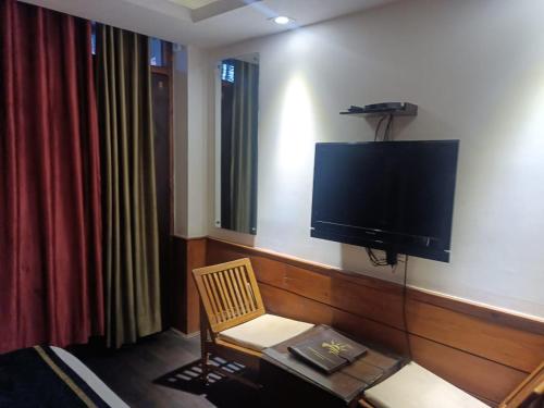a room with a flat screen tv on the wall at zoz sm7 in Shimla