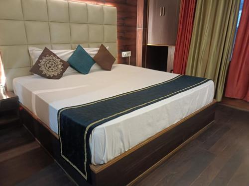a bedroom with a large bed with pillows on it at zoz sm7 in Shimla