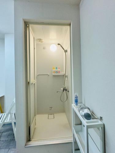 a small bathroom with a shower in a room at KOBAYASHi 東京 in Tokyo