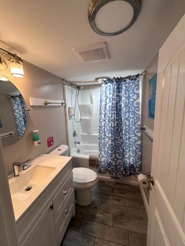 a bathroom with a toilet sink and a shower at Beach Block Parking Modern Decor Porch in Brigantine
