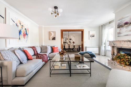 una sala de estar con un sofá y una mesa en El Jardín de Estrella, en Navacerrada