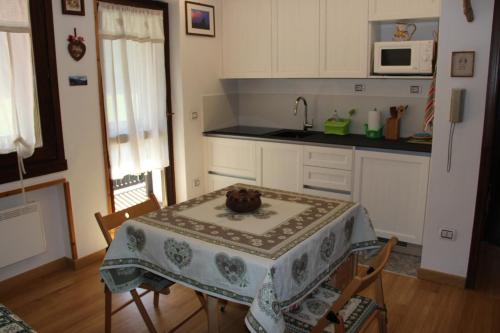 a kitchen with a table with a table cloth on it at Residence Fontanazzo in Campitello