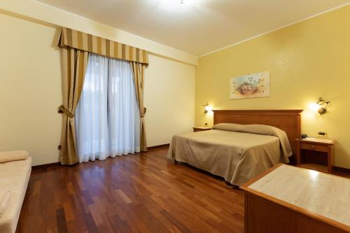 a hotel room with two beds and a window at Domus Hotel in Bagnoli del Trigno
