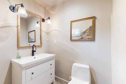 a bathroom with a sink and a toilet and a mirror at Modern Mountain Haven in Show Low