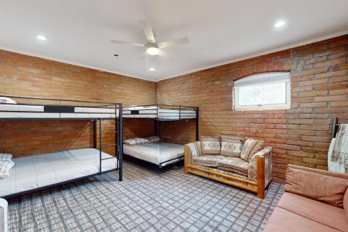 a room with two bunk beds and a couch at Modern Mountain Haven in Show Low