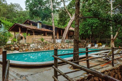a swimming pool with a house in the background at Jorullo Paradise in Puerto Vallarta