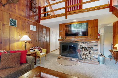 a living room with a fireplace with a tv above it at Dover Green 15F in Dover