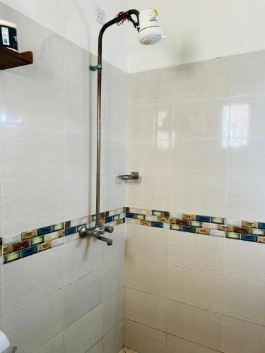 a bathroom with a shower with a glass door at Tranquil space with aerial Mombasa view in VOK off nyali road in Kisauni