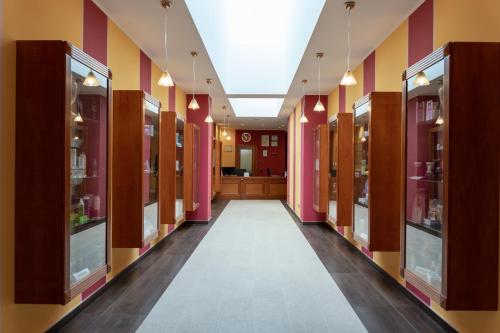 a hallway of a pharmacy with pink and yellow walls at Domus Hotel in Bagnoli del Trigno