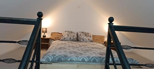 a bedroom with a bed with a black frame at Apartman Anđela 4 in Vrdnik