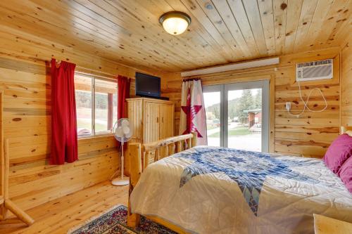 a bedroom with a bed in a log cabin at Deadwood Cabin with Foosball Table, Near Sanford Lab in Deadwood