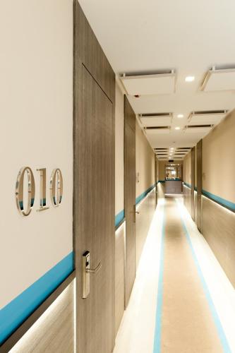 an empty corridor of an office building with a sign on the wall at Hotel Lombardia in Milan