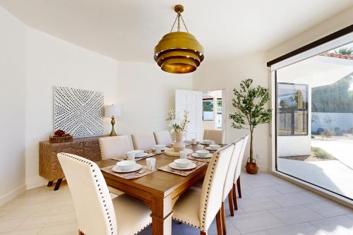 a dining room with a wooden table and chairs at Escape to Paradise Valley in Indian Wells