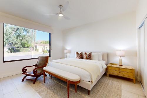 a white bedroom with a large bed and a window at Escape to Paradise Valley in Indian Wells