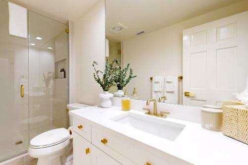 a bathroom with a sink and a toilet and a mirror at Escape to Paradise Valley in Indian Wells