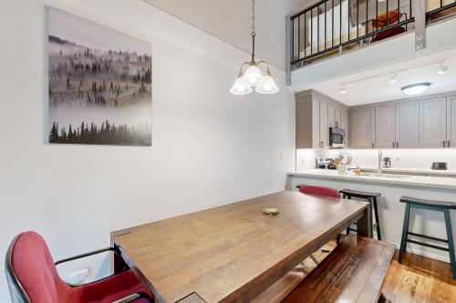 a kitchen with a wooden table and red chairs at 2 Bed 2 Bath Apartment in Carnelian Bay in Carnelian Bay