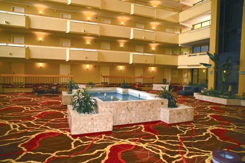 a large lobby with a pool in the middle of a building at MCM Elegante Hotel & Suites Lubbock in Lubbock