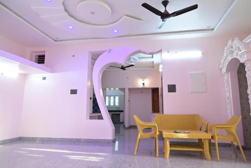 a room with a table and chairs and a ceiling at Le Joie Luxury in Puducherry