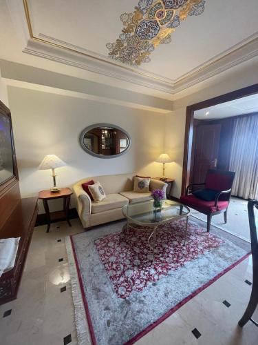 a living room with a couch and a table at ITC Maurya, a Luxury Collection Hotel, New Delhi in New Delhi