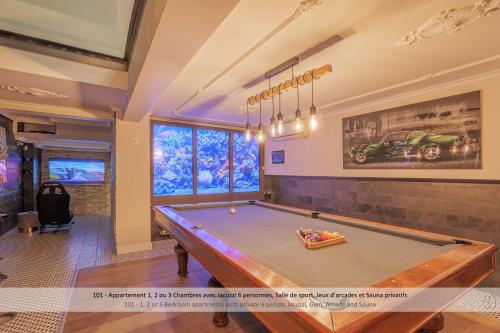 a pool table in a living room with avertisement for at Au 30 Lille Centre Grand Palais in Lille