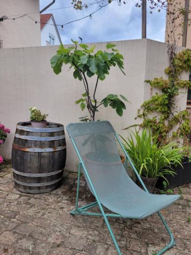 a blue chair sitting next to a barrel at das Höfchen Stadecken in Stadecken-Elsheim