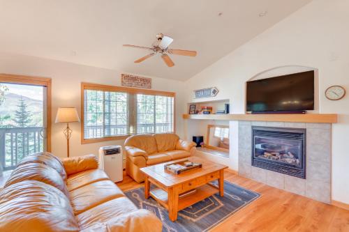 a living room with a couch and a fireplace at Condo with Mtn View Less Than 1 Mi to Steamboat Resort! in Steamboat Springs
