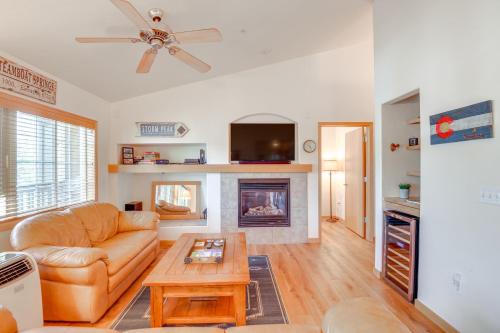 a living room with a couch and a fireplace at Condo with Mtn View Less Than 1 Mi to Steamboat Resort! in Steamboat Springs