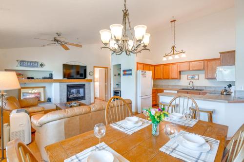 a kitchen and living room with a table and a couch at Condo with Mtn View Less Than 1 Mi to Steamboat Resort! in Steamboat Springs