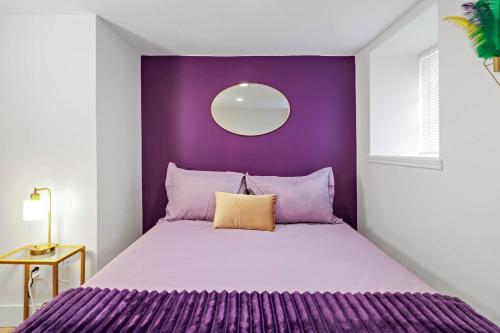 a purple bedroom with a bed with a purple headboard at Soulard 4 Bedroom Retreat Near Downtown with Patio and Parking in Soulard