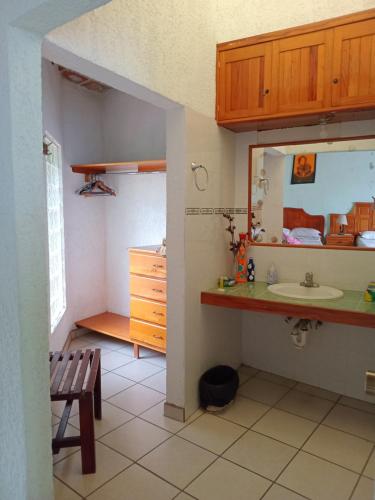a bathroom with a sink and a counter with a mirror at Hotel Casa Corita in Jala