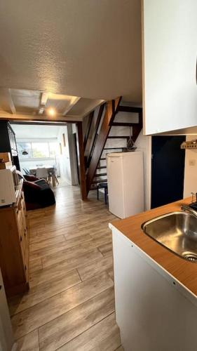 a kitchen with a sink and a kitchen with a staircase at Charmant T2 Mezzanine Port Leucate in Leucate