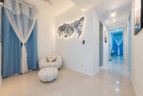 a hallway with a room with blue walls and white walls at Emerald Hill Kuala Lumpur by HLG in Kuala Lumpur
