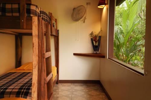 a bedroom with a bunk bed and a window at Santa Juana Lodge & Nature Reserve in Quepos