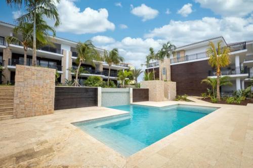 a swimming pool in front of a building at Sint Michiel, Curaçao Apartaments in Julianadorp