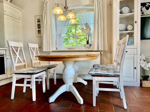 a kitchen with a table and chairs and a window at Roter Apfel in Boldixum