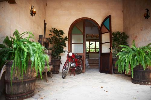 a red motorcycle parked in front of a building at Agroturisme Perola - Only Adults in Llucmajor