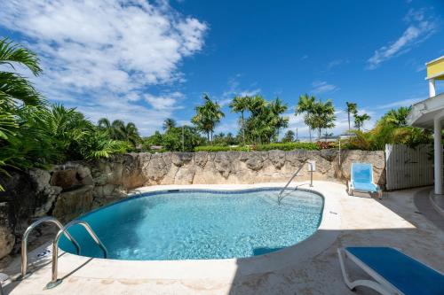 a swimming pool with a rock wall next to anergynergynergynergyploadpload at Vida Mejor-Waterfall in Saint James