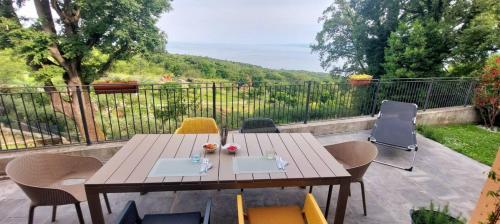 a wooden table and chairs on a patio at Casa Vista Mare in Muggia