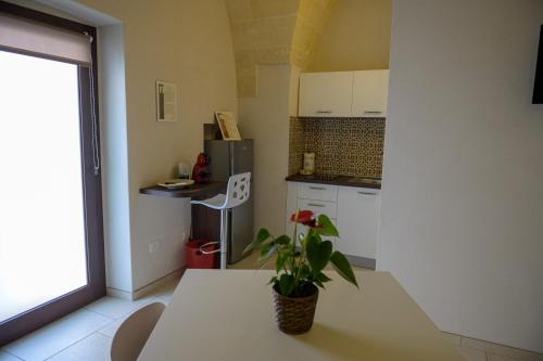 a kitchen with a table with a plant on it at Bbatà in Grottaglie