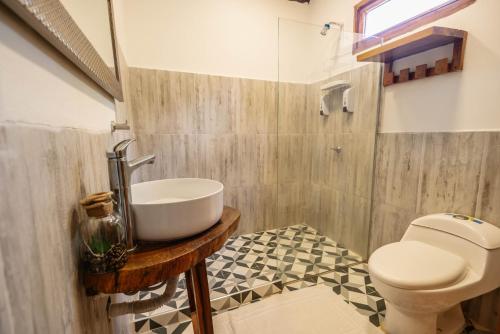 a bathroom with a sink and a toilet at Finca Escondida in Palomino