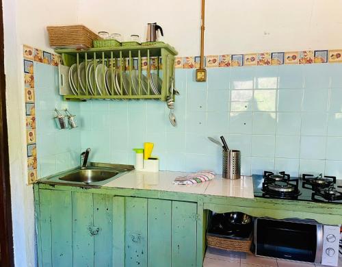 a kitchen with a sink and a counter top at Camping El Madroñal in Fuenteheridos