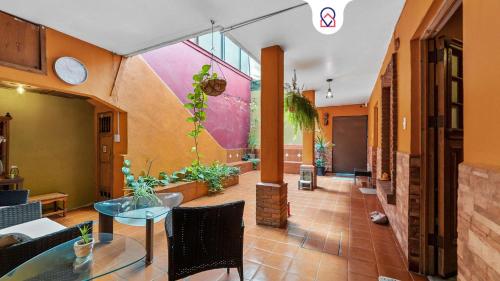 a lobby with a glass table and some plants at Charming 2-Bedroom Retreat in Lomas de Bezares in Mexico City