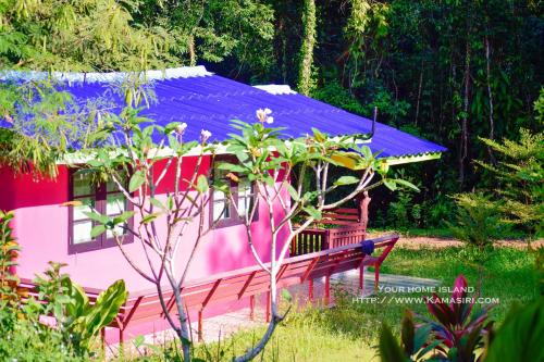 a pink and purple house with a purple roof at Kama Siri Koh Kood in Ko Kood