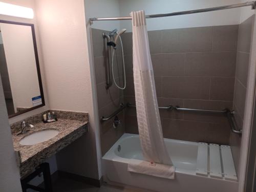 a bathroom with a shower and a sink and a tub at Comfort Inn & Suites in Aztec