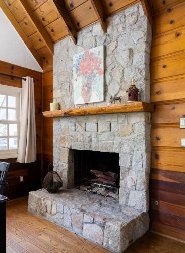 a living room with a stone fireplace in a house at Gingerbread Gardens in Twin Peaks