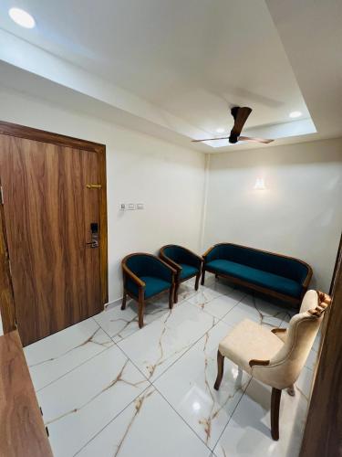 a waiting room with two chairs and a door at Shanthi Tourist Home in Pathanāmthitta
