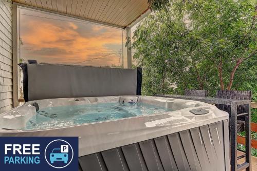 a hot tub sitting on a patio with a table at Antique CAT - 2 King Bed & Hot Tub - Free Parking in Quebec City