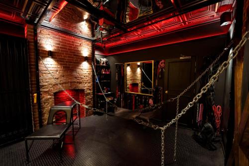 a room with a chair and a fireplace at The Hidden Dungeon in Brighton & Hove
