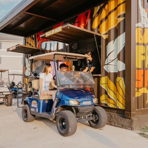 a group of people riding a golf cart at Bayshore Resort At Put-In-Bay in Put-in-Bay