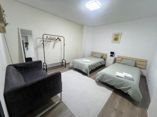 a living room with two beds and a couch at Appartement Verviers in Verviers
